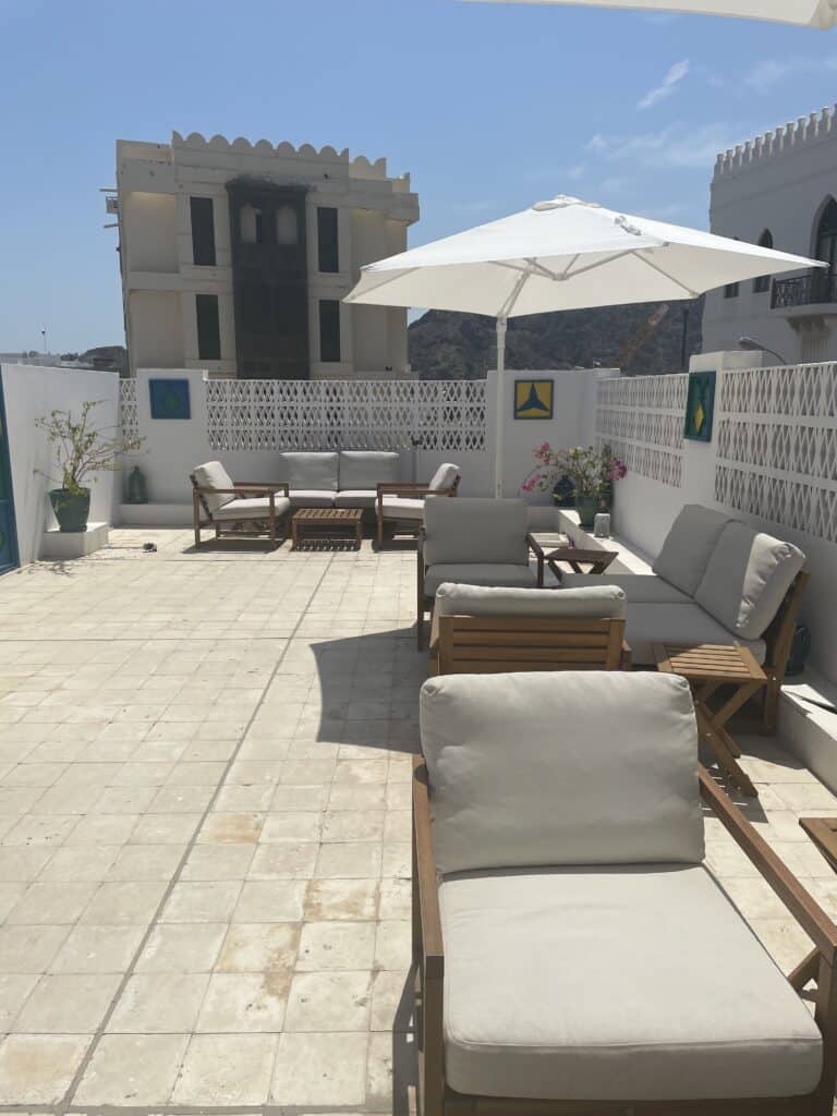 White sunlit terrace on the top floor of Kadm Cafe in Matrah, Oman