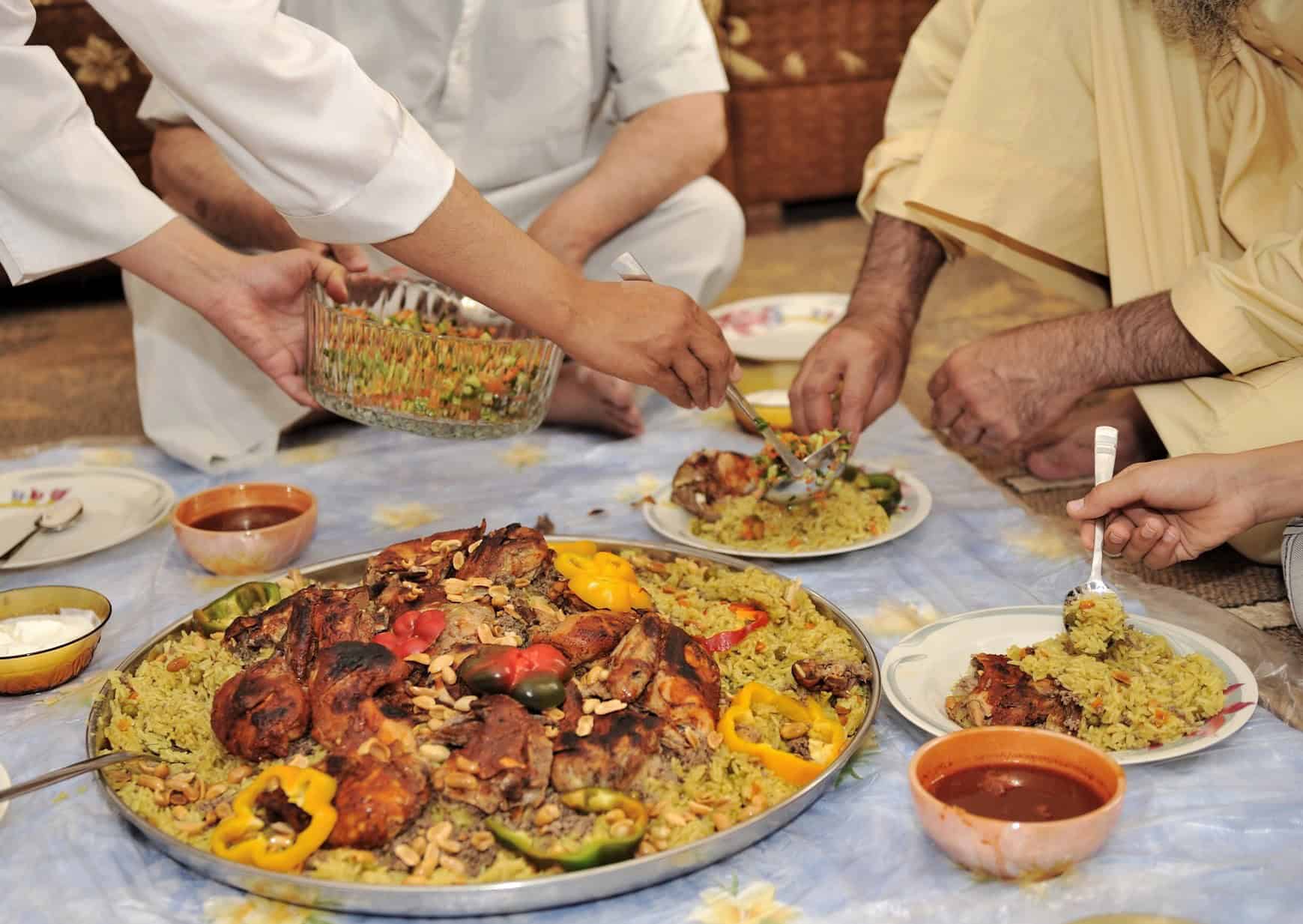 Omani men eating together on the floor