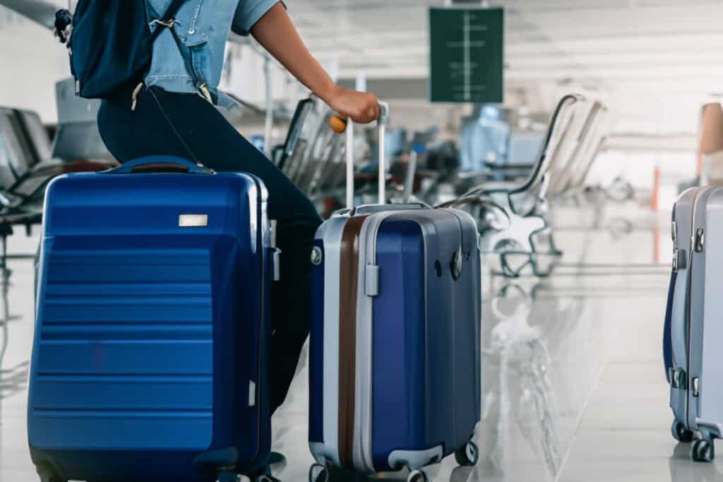 suitcases next to a man at the airport