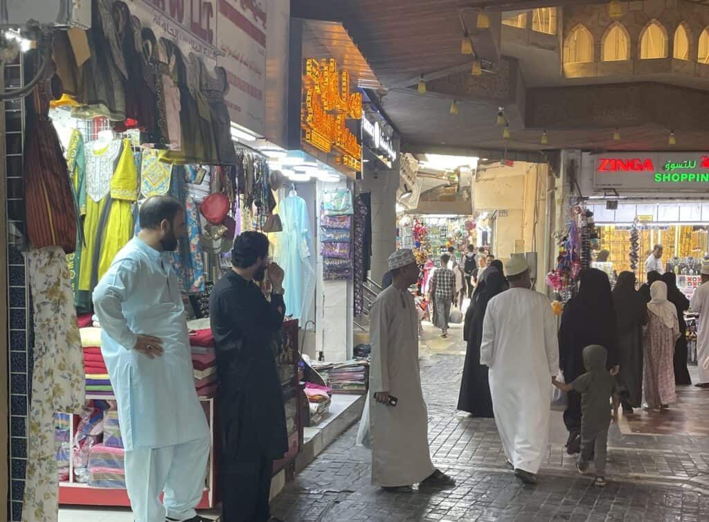 Visitors and shopkeepers mingle at Mutrah Souq