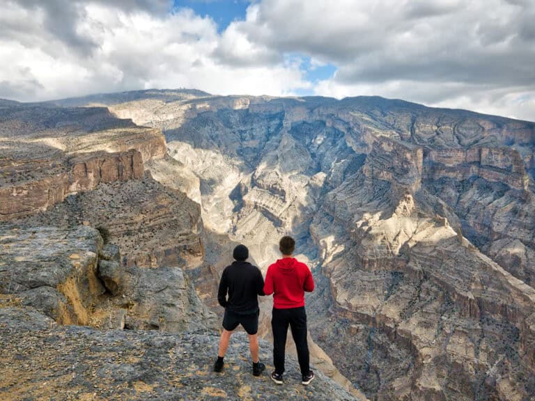 Two men hiking in the Hajar Mountains in Oman