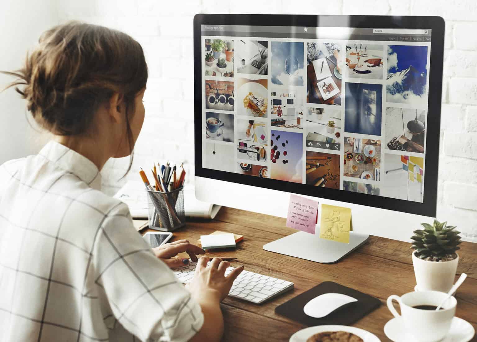 woman designing a travel moodboard on her computer