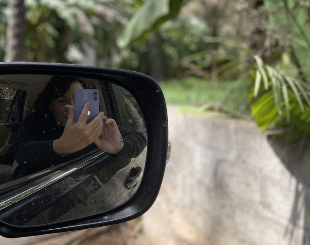 A picture of the author of the Joussour to Oman taking a photograph in palm groves inOman
