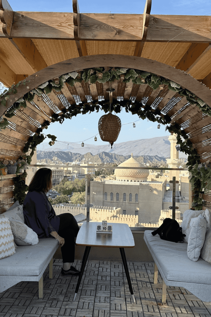 Christine, the creator of Joussour to Oman, looking out over Nizwa from a cafe terrace